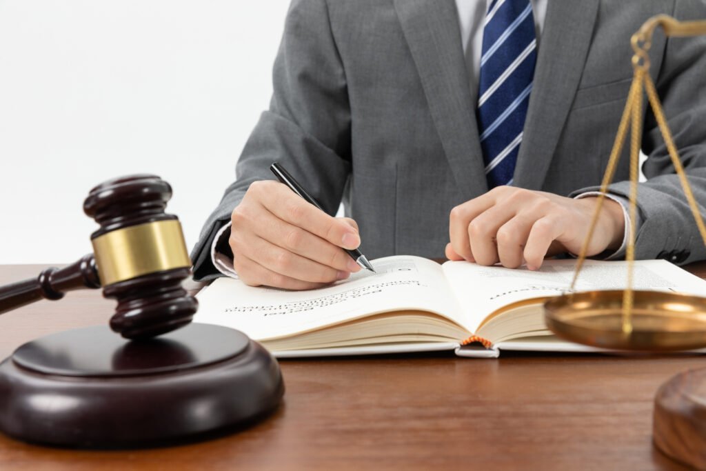 Civil Law closeup shot person writing book with gavel table